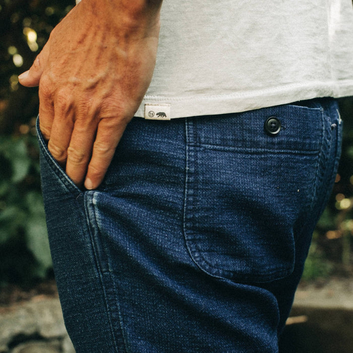 fit model wearing The Apres Pant in Indigo, hand in pocket