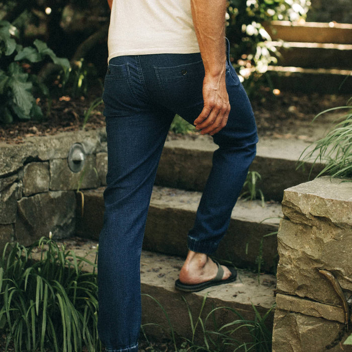 fit model wearing The Apres Pant in Indigo, walking up steps