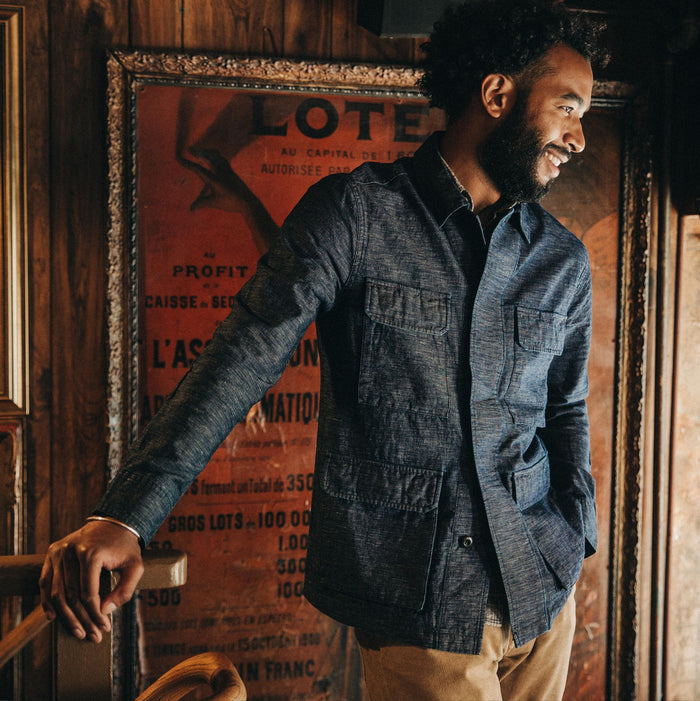 fit model wearing The BDU Shirt Jacket in Indigo Slub, smiling, hand on railing