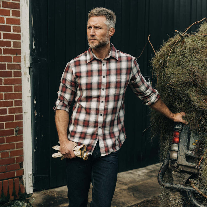 fit model leaning against a car wearing The California in Brick Plaid Ombre Twill