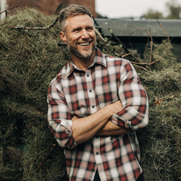 fit model with his arms crossed wearing The California in Brick Plaid Ombre Twill