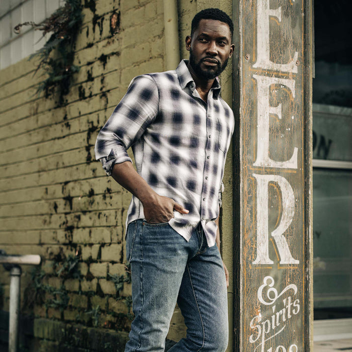 fit model leaning against the wall wearing The California in Storm Plaid Ombre Twill