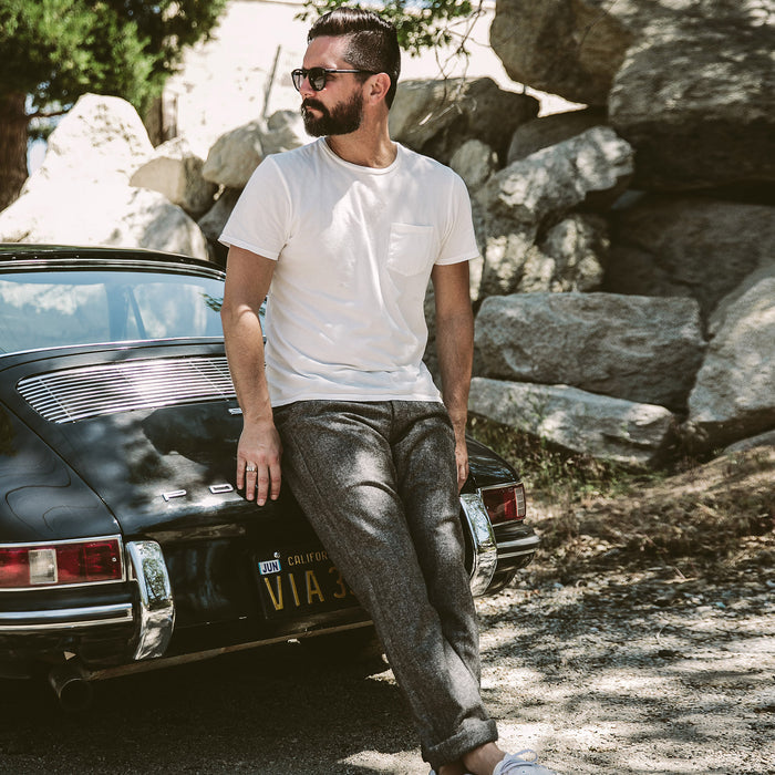 Our fit model leaning against a Porsche