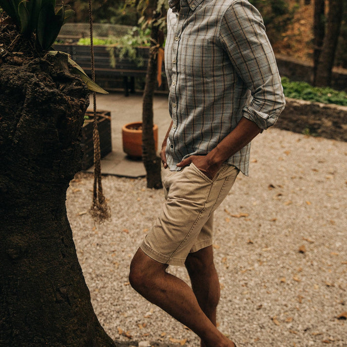 fit model wearing The Camp Short in Khaki Herringbone, hand in pocket walking left