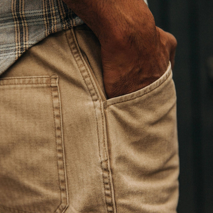 fit model wearing The Camp Short in Khaki Herringbone, hand in pocket, close up shot