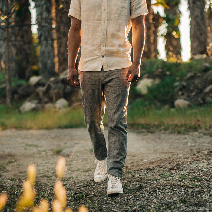fit model walking in The Easy Pant in Charcoal Herringbone