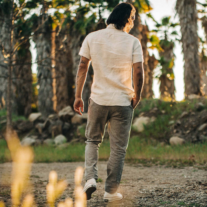 fit model showing the back of The Easy Pant in Charcoal Herringbone