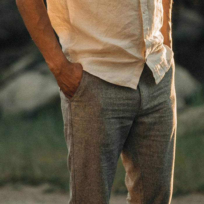 fit model with his hand in the pocket of The Easy Pant in Charcoal Herringbone