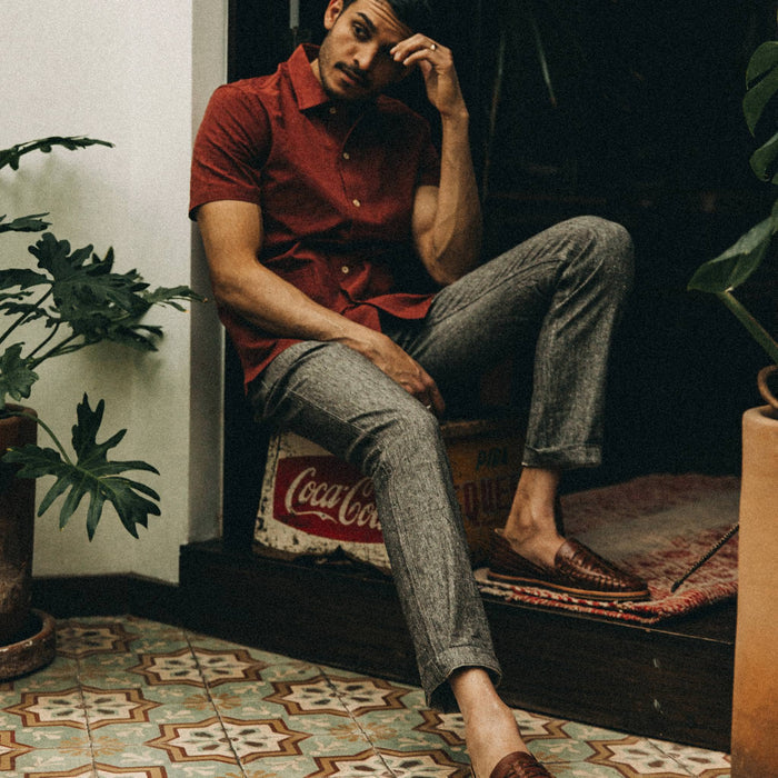 fit model wearing The Easy Pant in Espresso Linen, sitting down indoors