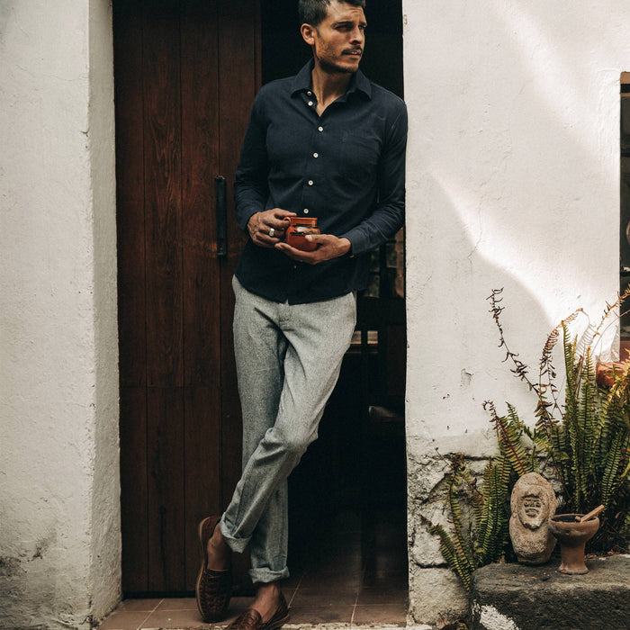 fit model wearing The Easy Pant in Navy Herringbone, drinking coffee