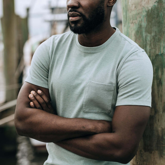fit model with his arms crossed wearing The Heavy Bag Tee in Slate