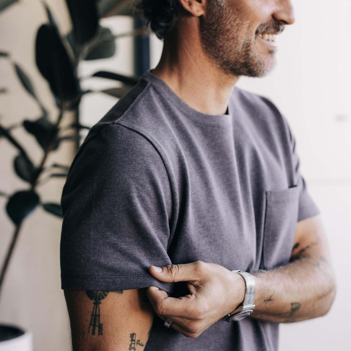 fit model adjusting the sleeve on The Heavy Bag Tee in Smoke