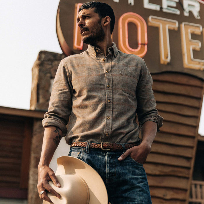fit model wearing shirt standing in front of motel