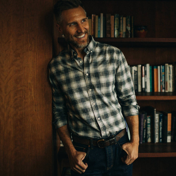 fit model smiling and leaning against a wall in The Jack in Navy Plaid