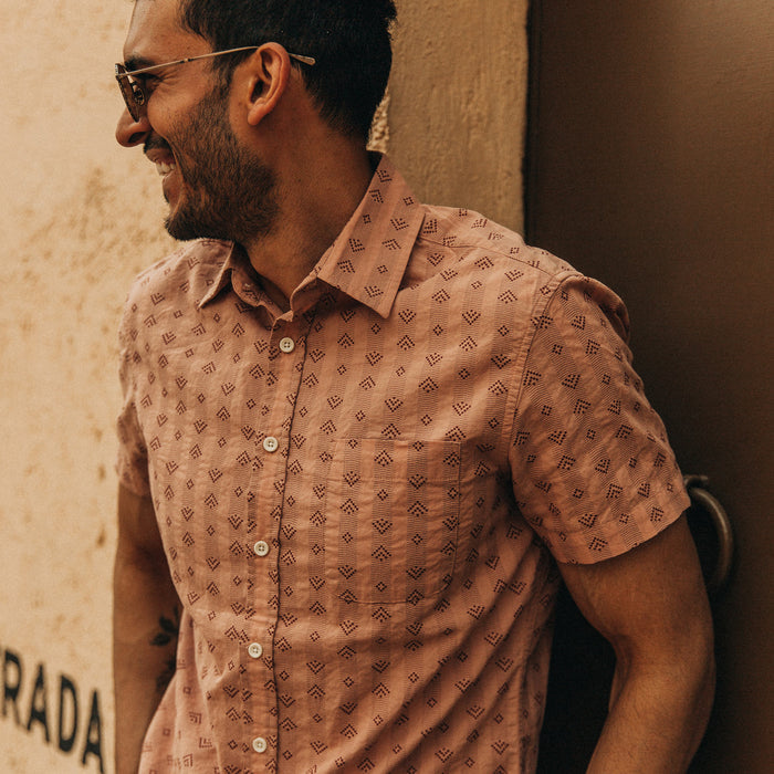 fit model wearing The Short Sleeve California in Arrowhead, laughing, looking left next to wall