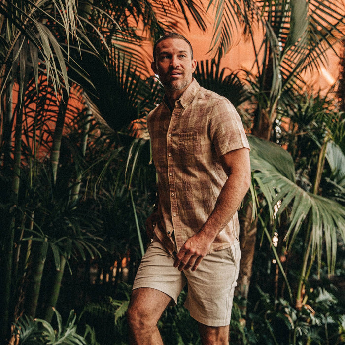 fit model wearing The Short Sleeve Jack in Red Madras, greenery behind