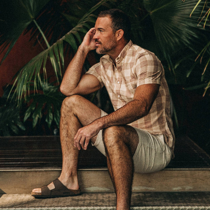 fit model wearing The Short Sleeve Jack in Red Madras, sitting on ledge