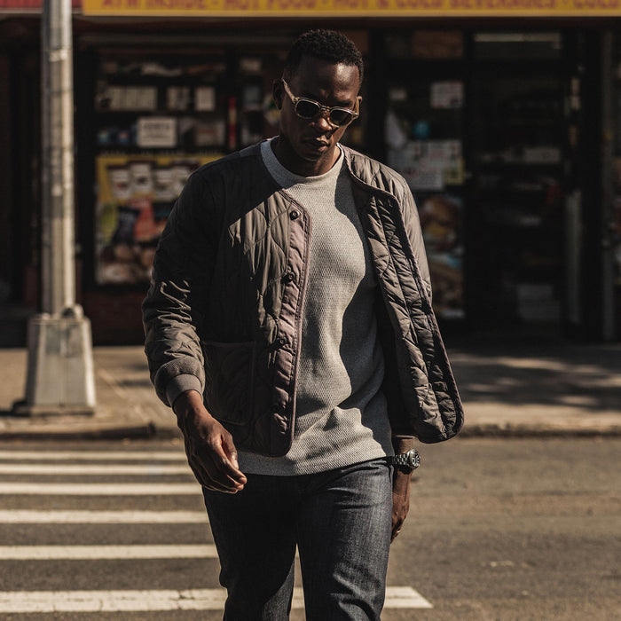 our fit model wearing The Taylor Stitch x Alpha Industries ALS/92 in Raven—walking across street