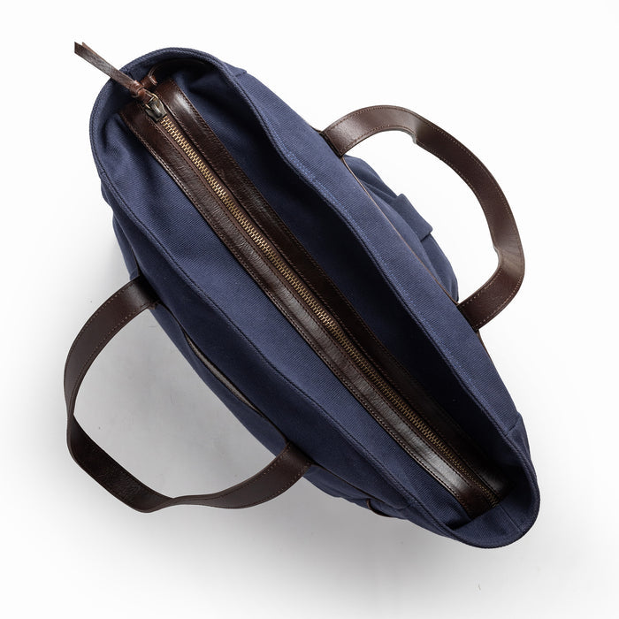 flatlay of The Utility Bag in Navy, shown zipped from the top