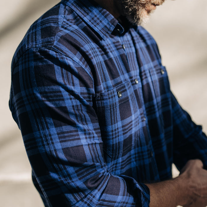 fit model adjusting sleeves on The Utility Shirt Rinsed Indigo Plaid