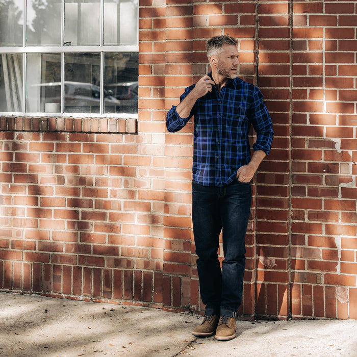 fit model standing wearing The Utility Shirt Rinsed Indigo Plaid