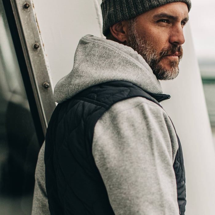 our fit model wearing The Vertical Vest in Charcoal—side shot