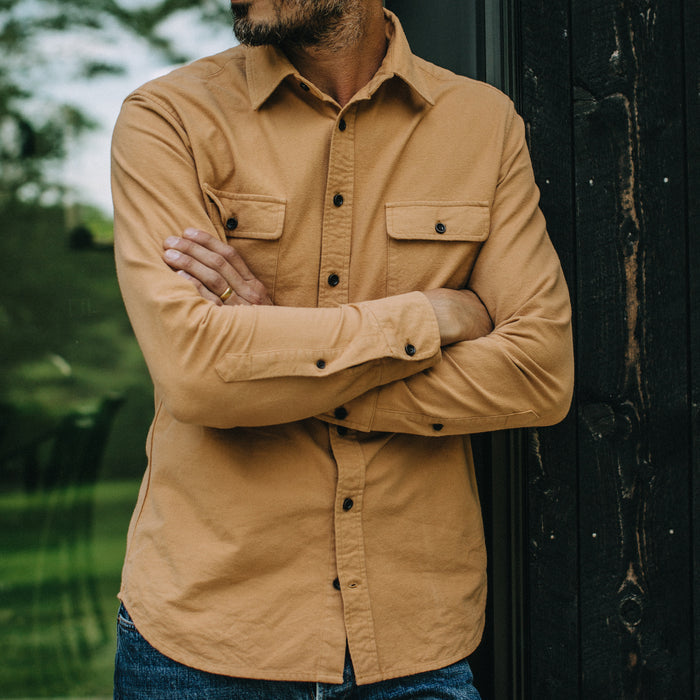 fit model with his arms crossed wearing The Yosemite Shirt in Tan