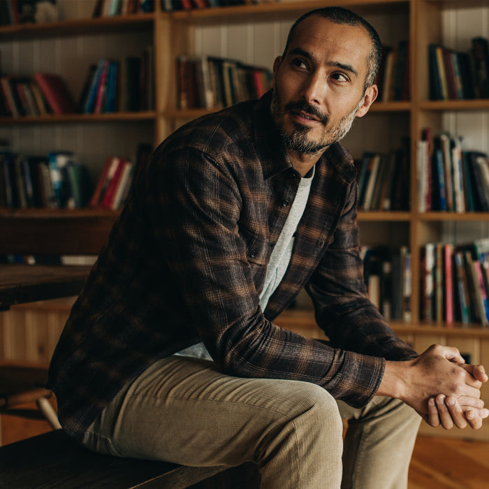 Fit model sitting in The Yosemite Shirt in Timber Shadow Plaid
